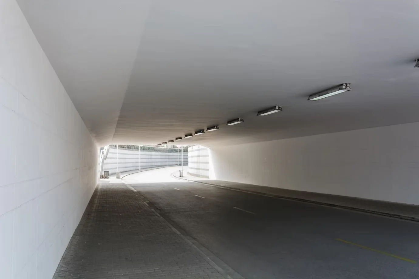 Road tunnel with white painted walls and ceiling